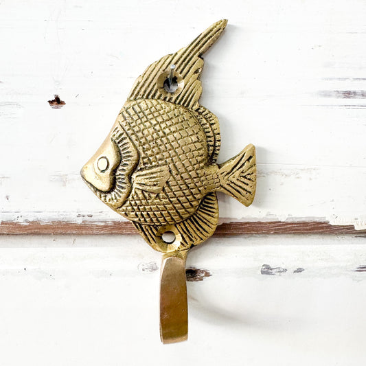 Brass Angel Fish wall hook on a white wooden background