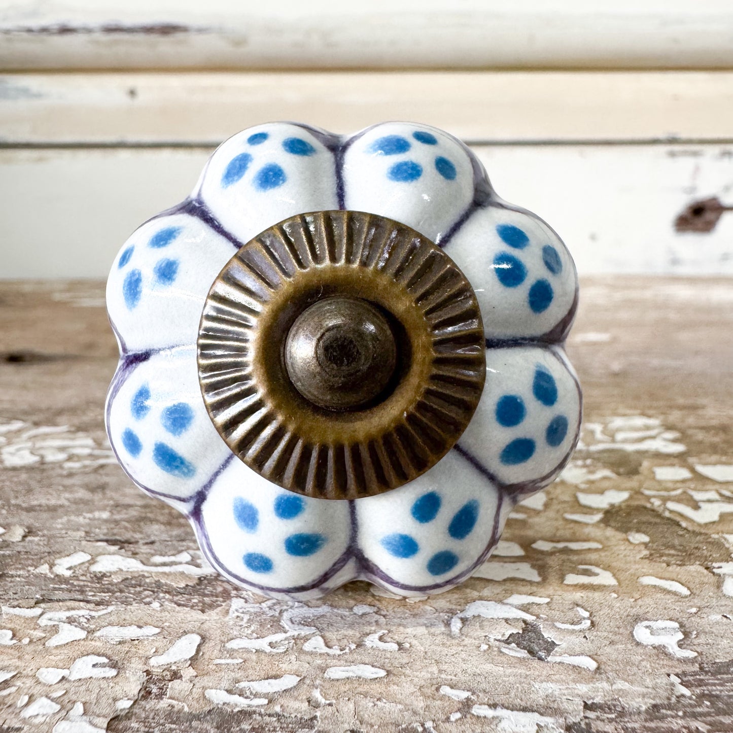 Decorative ceramic knob with blue polka dots AND a flower shape