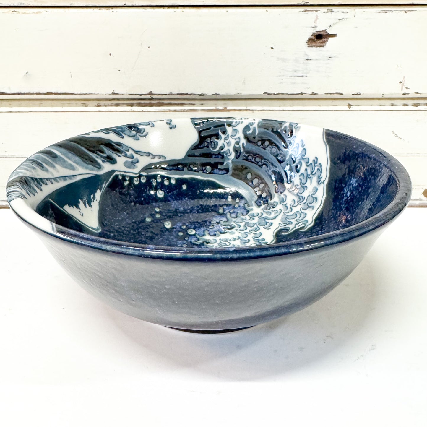 Concept Japan - Namiura Bowl. Ceramic bowl with blue and white wave design.