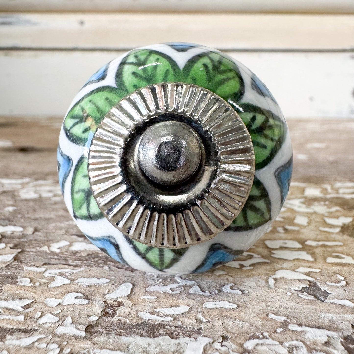 Decorative ceramic knob with green leaf and blue pattern
