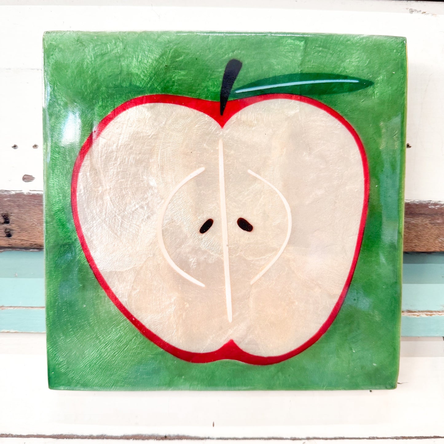 Painting of a sliced apple on a green background Jones & Co - Superette Apple Tile