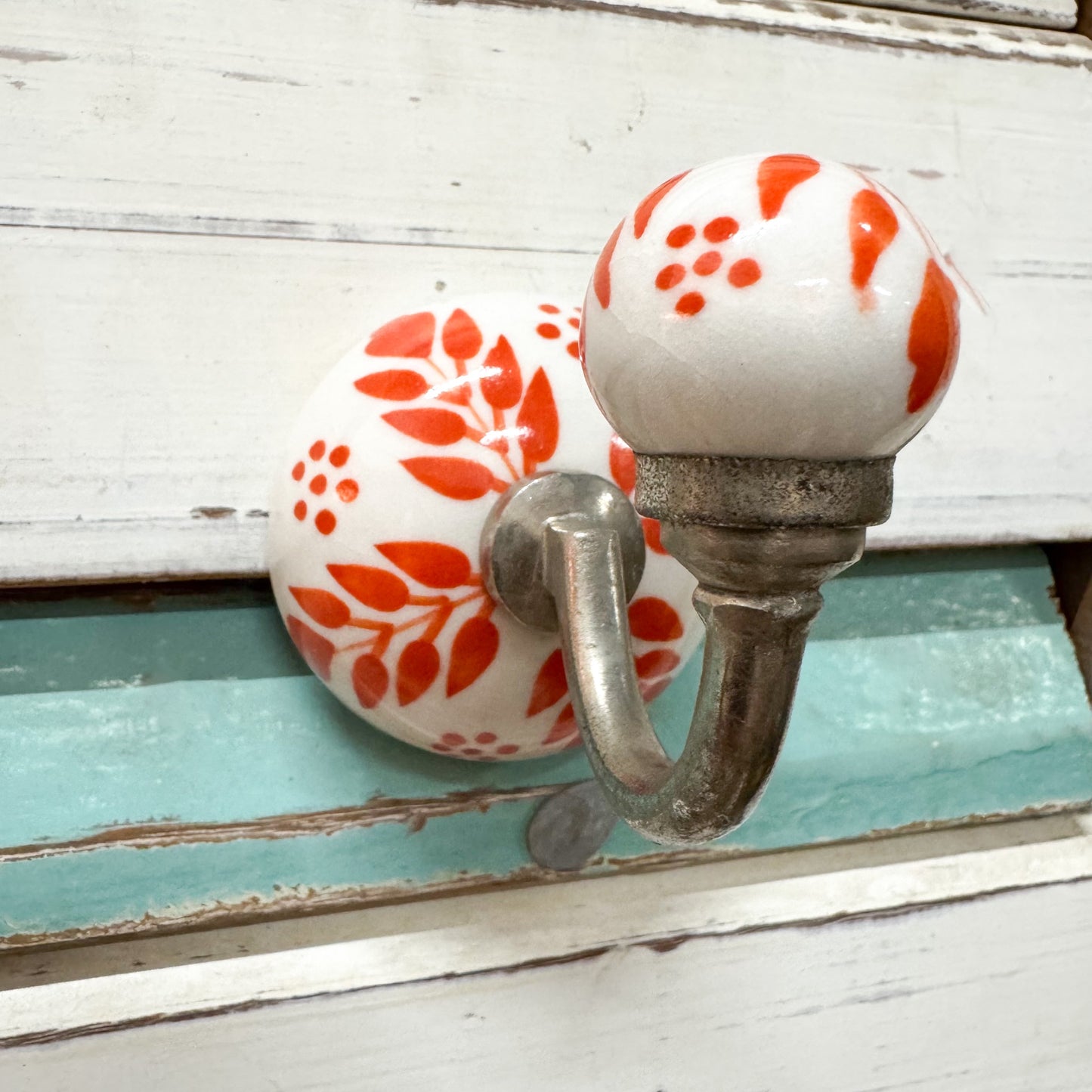 Decorative hook with floral patterned knobs