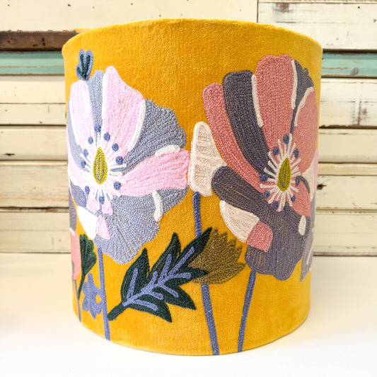 Yellow cylindrical lamp shade with floral embroidery on velvet