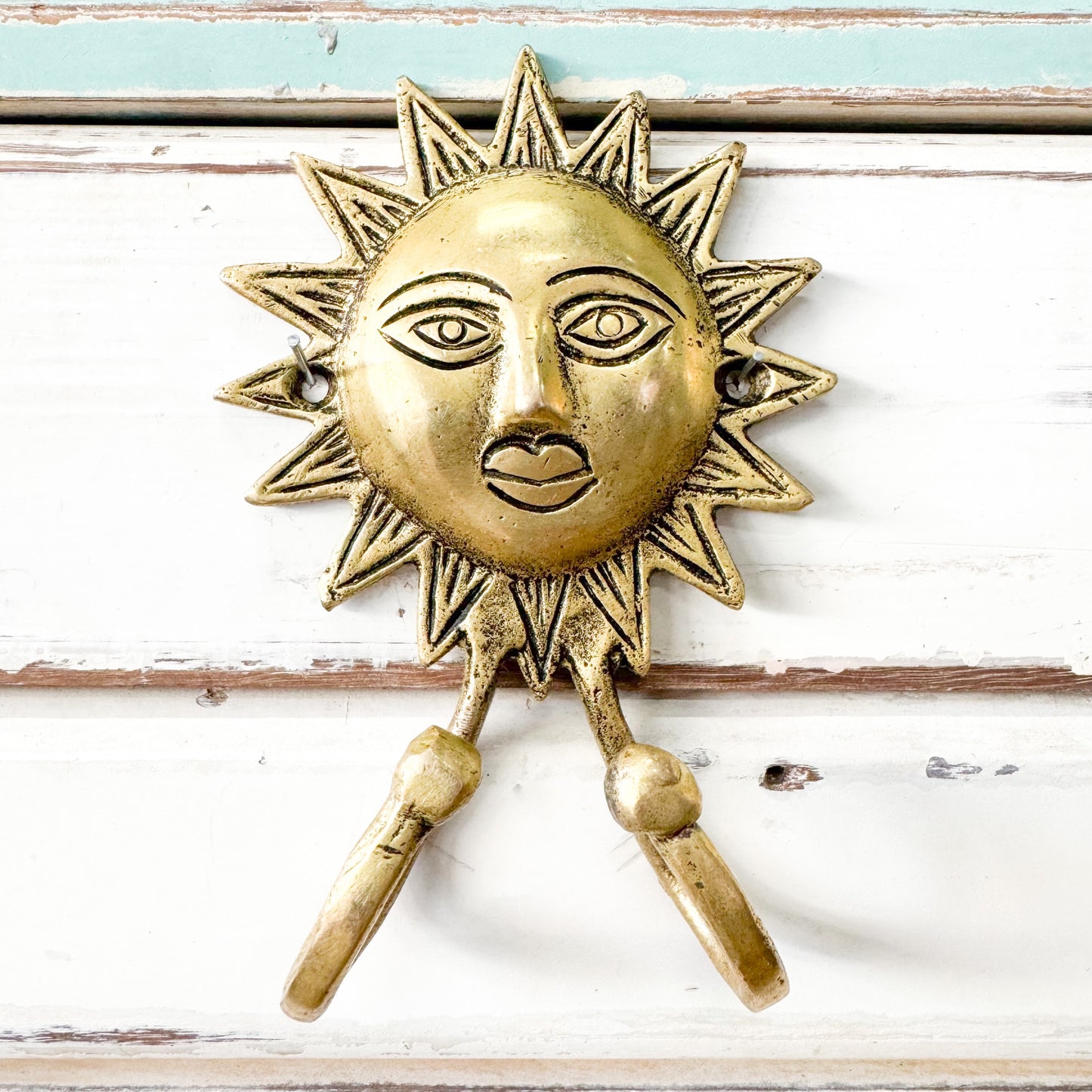 Shiny gold sun with two hooks