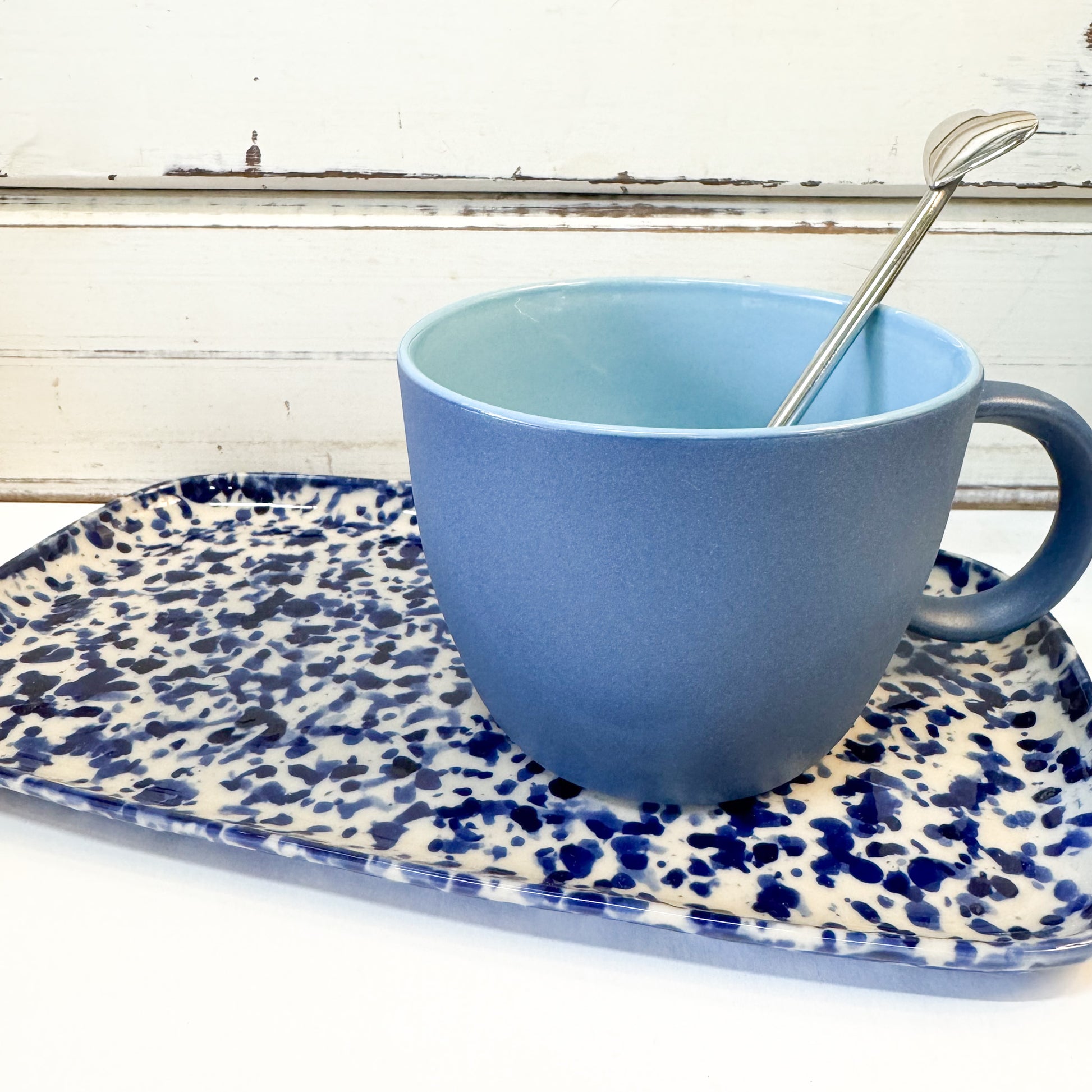 ceramic blue coffee cup on plate