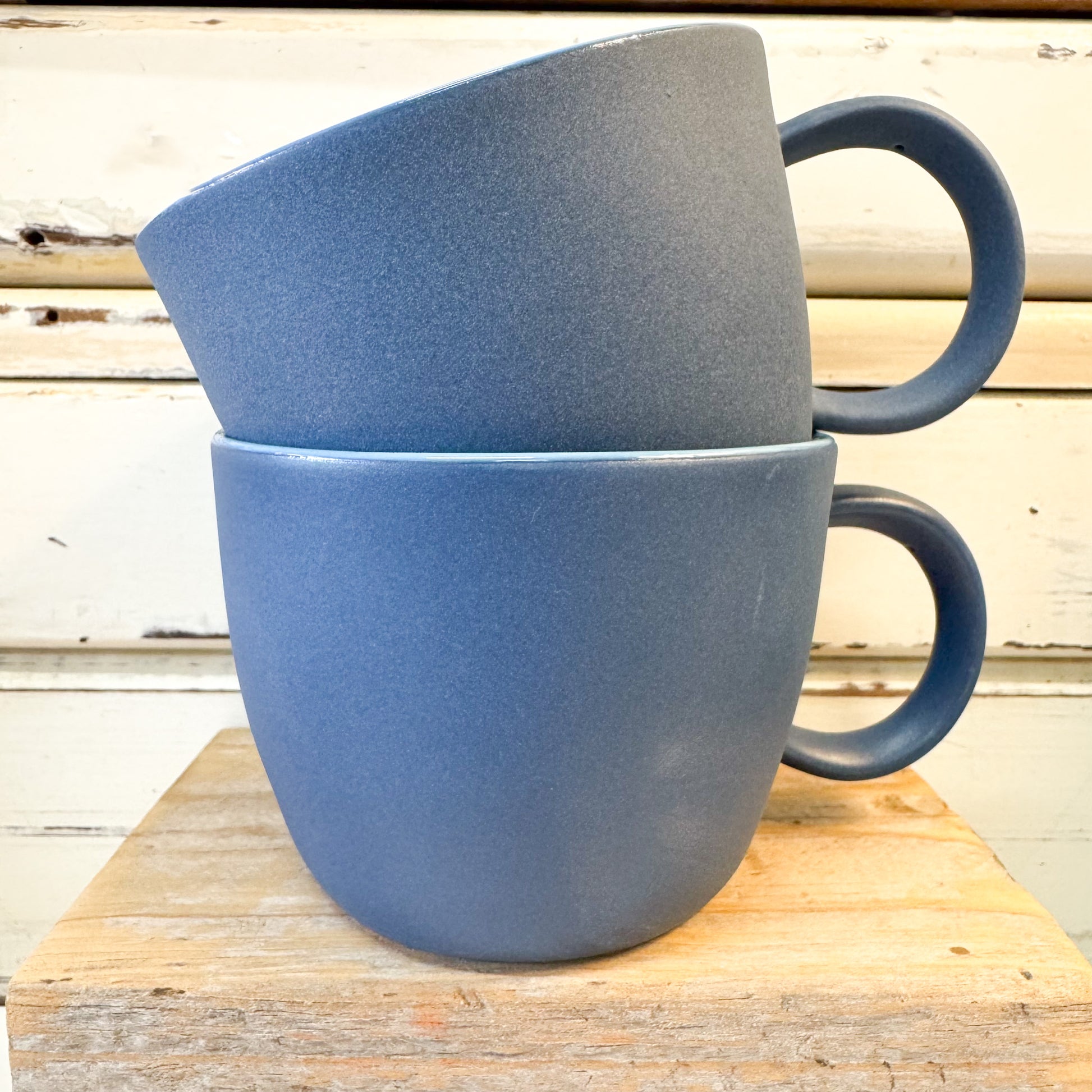 two ceramic blue coffee mugs