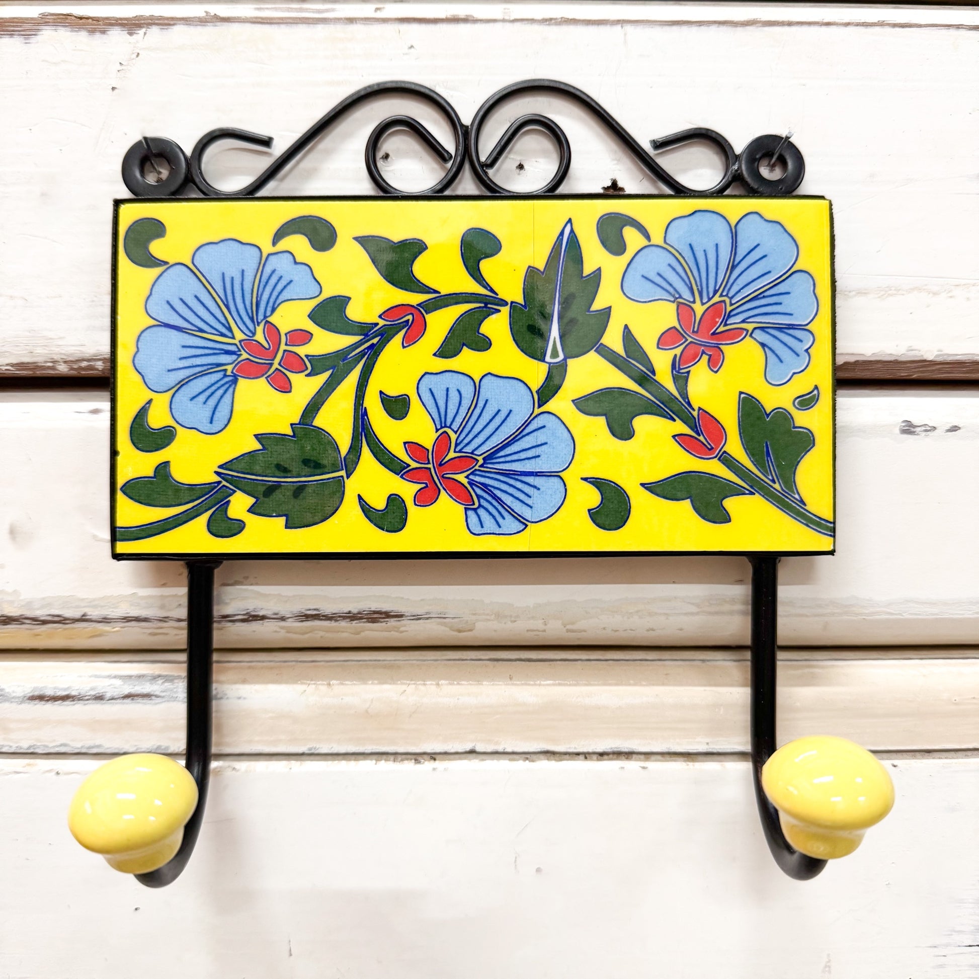 Decorative wall TILE hook with floral design on a yellow background