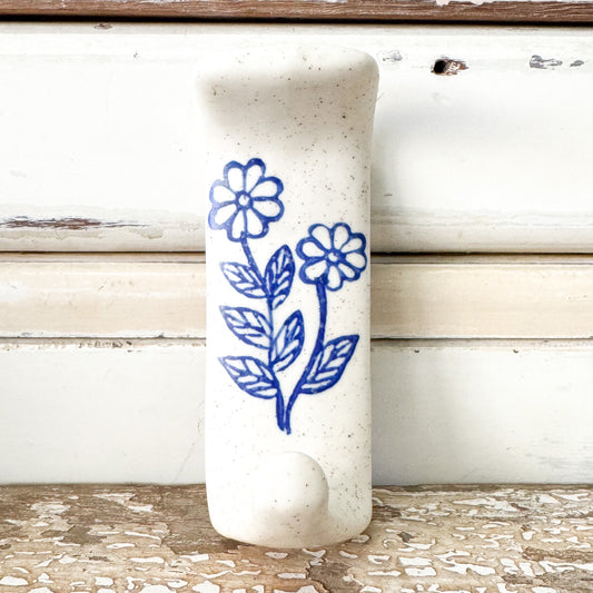 White ceramic adhesive hook with blue floral design 