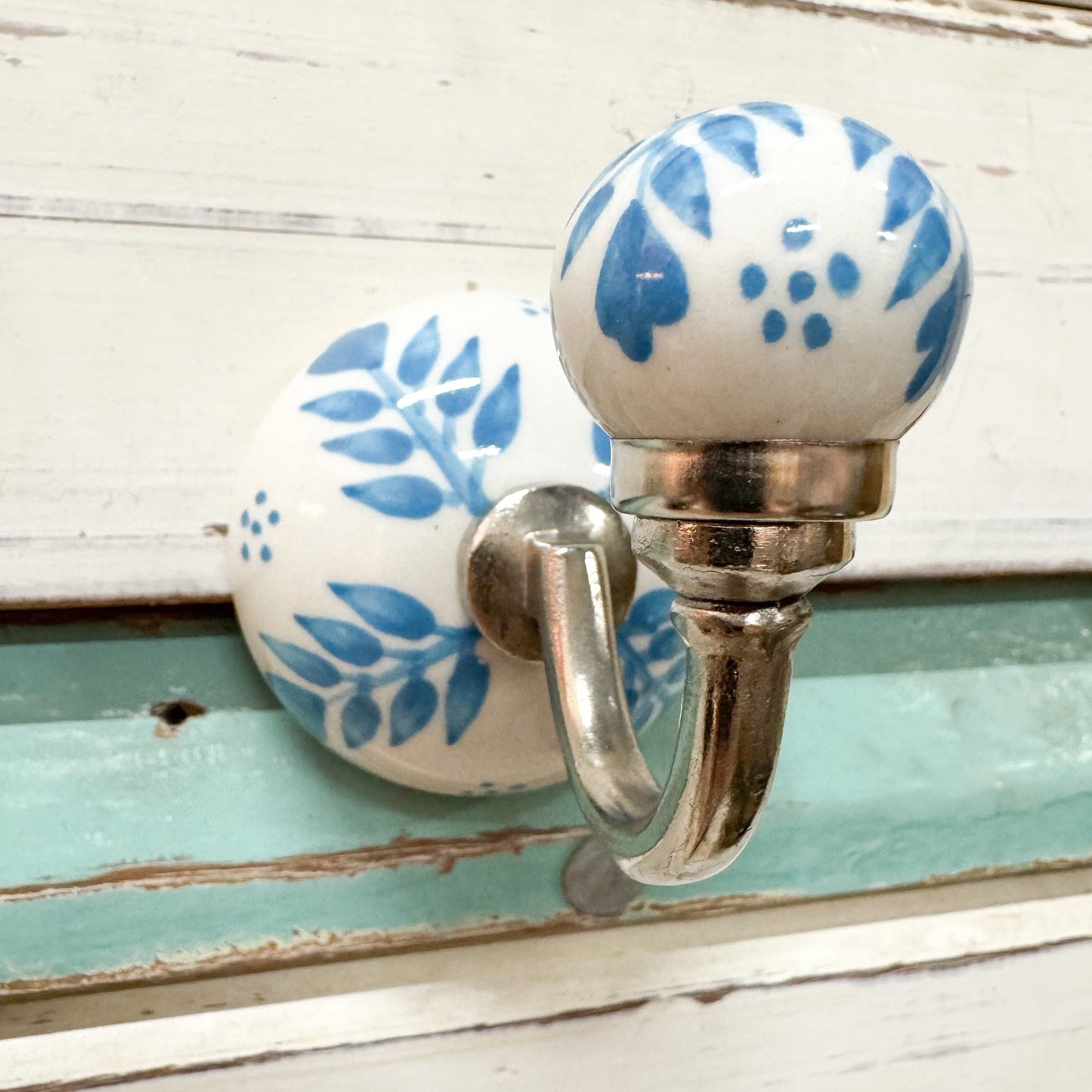 Decorative wall hook with blue floral design 
