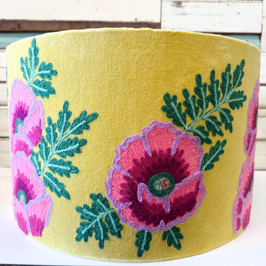 Embroidered pink floral design on a yellow velvet shade