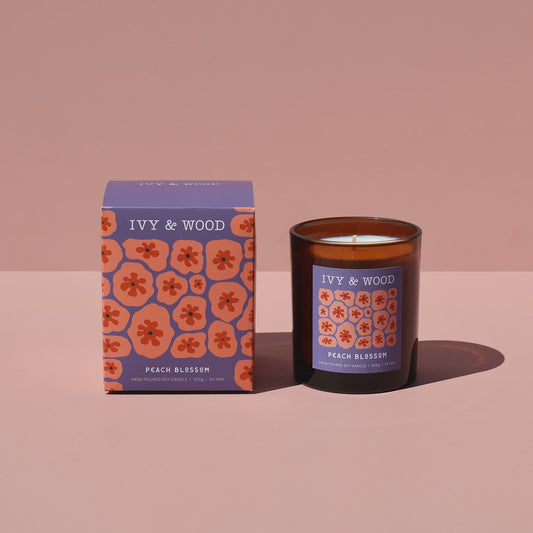 IVY & WOOD candle and packaging on a pink background - Ivy & Wood - Peach Blossom Scented Candle