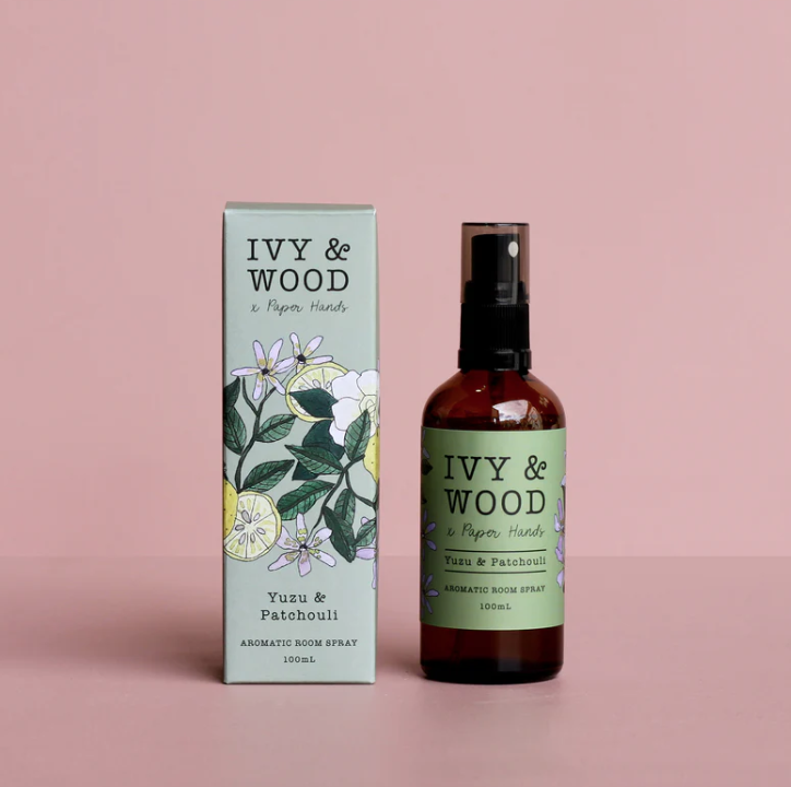 Ivy & Wood Yuzu & Patchouli room spray and packaging on a pink background