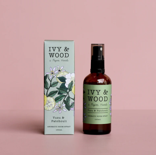 Ivy & Wood Yuzu & Patchouli room spray and packaging on a pink background