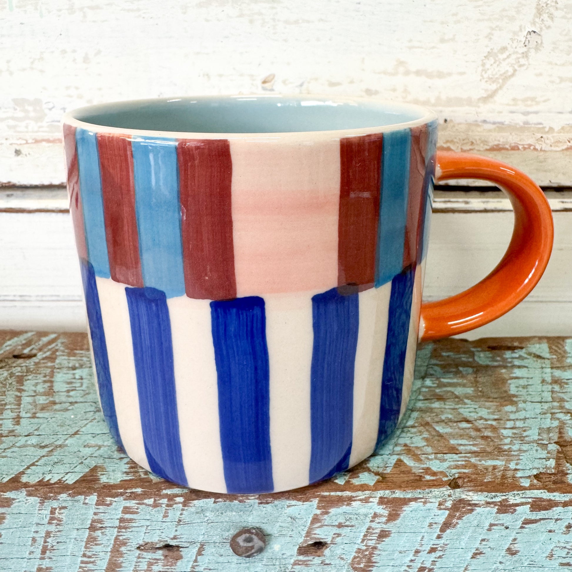 Colorful striped mug with an orange handle. Jones & Co - Bloomie Blue Stripe Mug