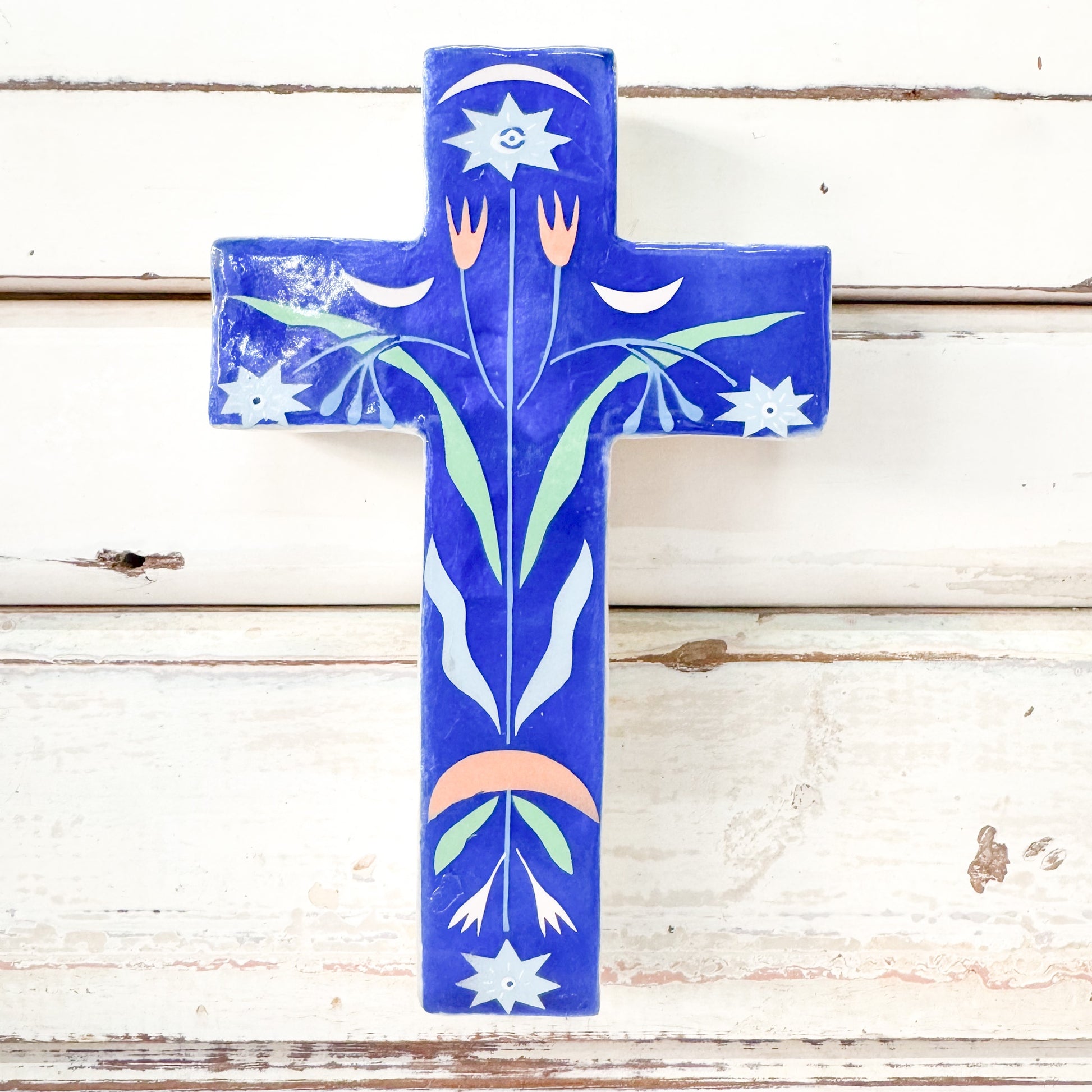 Decorative blue capiz cross with floral patterns. Jones & Co - Fable Blue Floral Small Cross