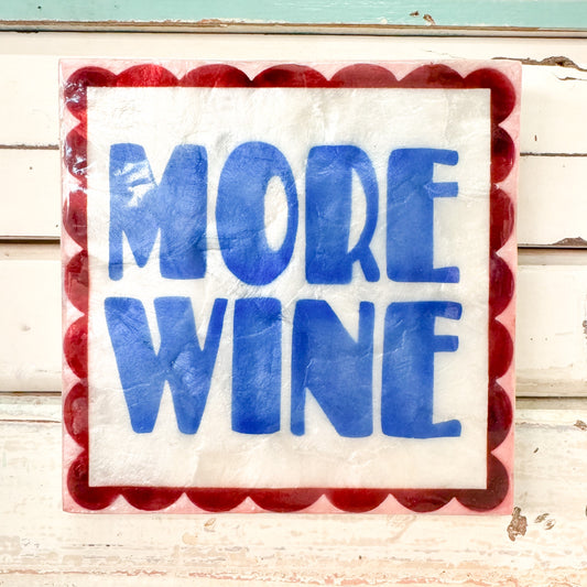 Decorative sign with 'MORE WINE' text on a red and white scalloped border. Jones & Co - Fun House Wine Tile
