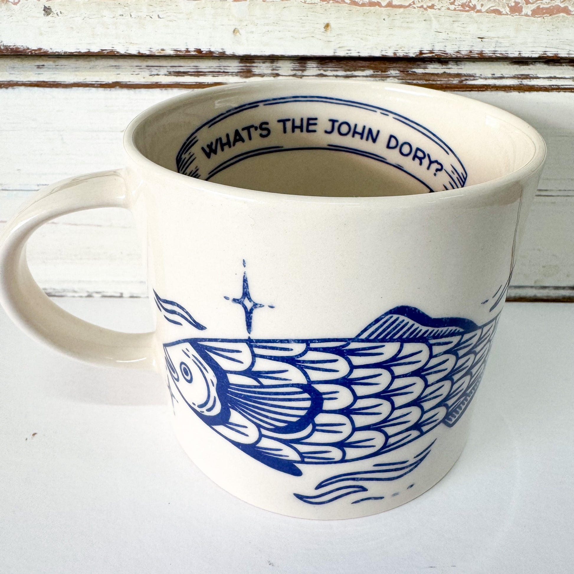 White mug with blue fish design and text 'What's the John Dory?' on a white background - Jones & Co - Inked Mug - John Dory