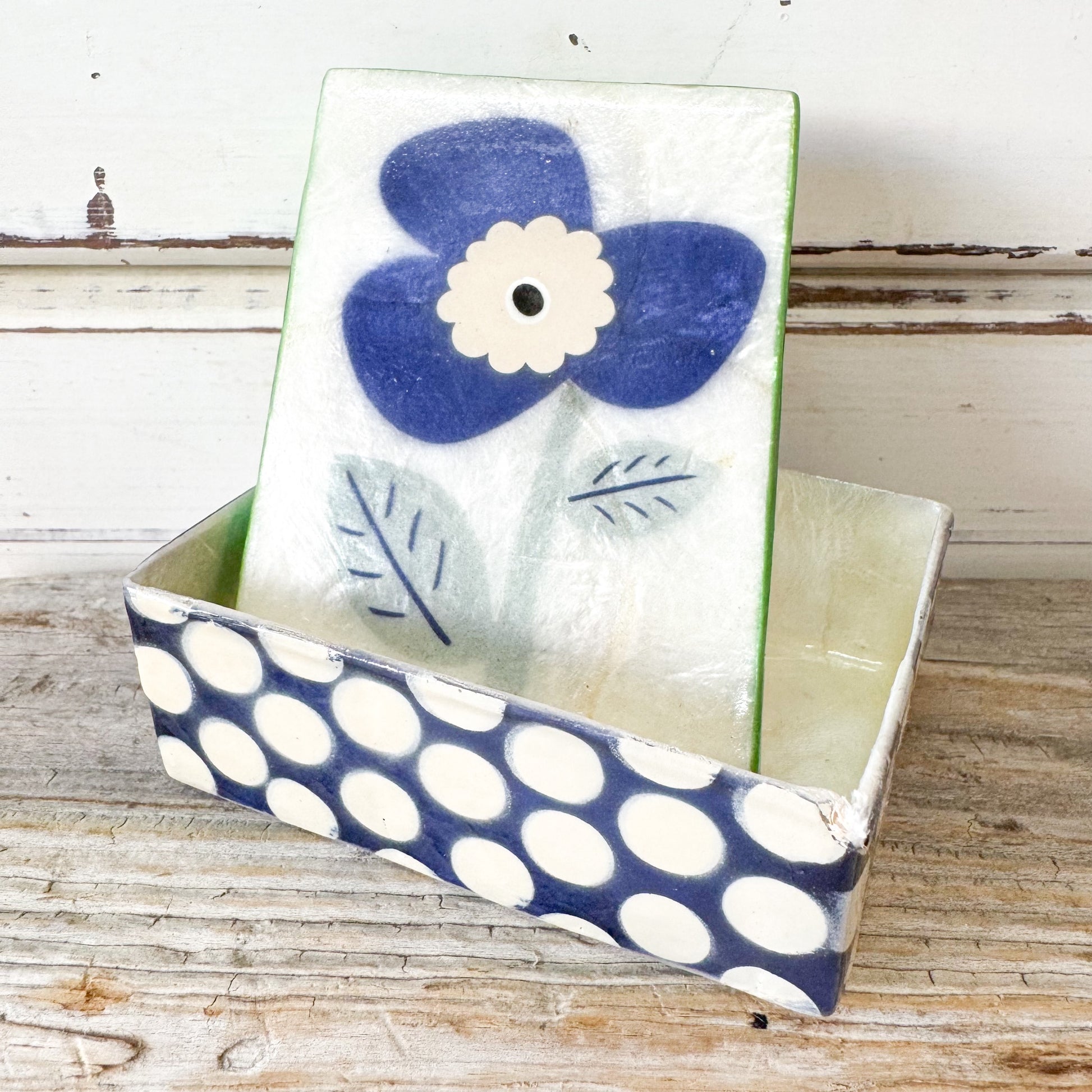 Decorative box with a blue flower design 