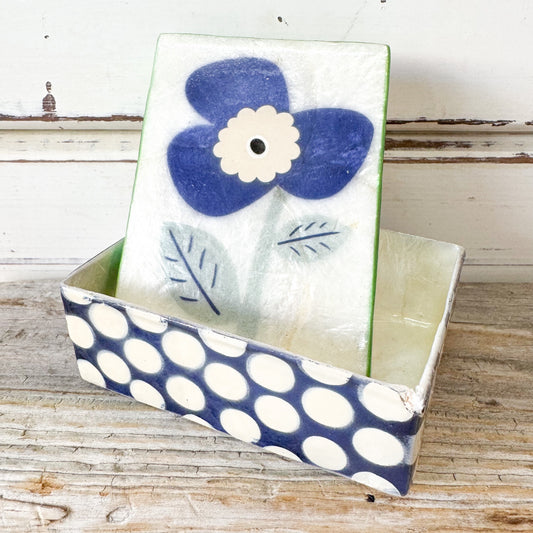 Decorative box with a blue flower design 