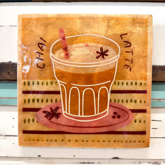 Shiny Capiz shell tile with a design of a chai latte and text on a beige background