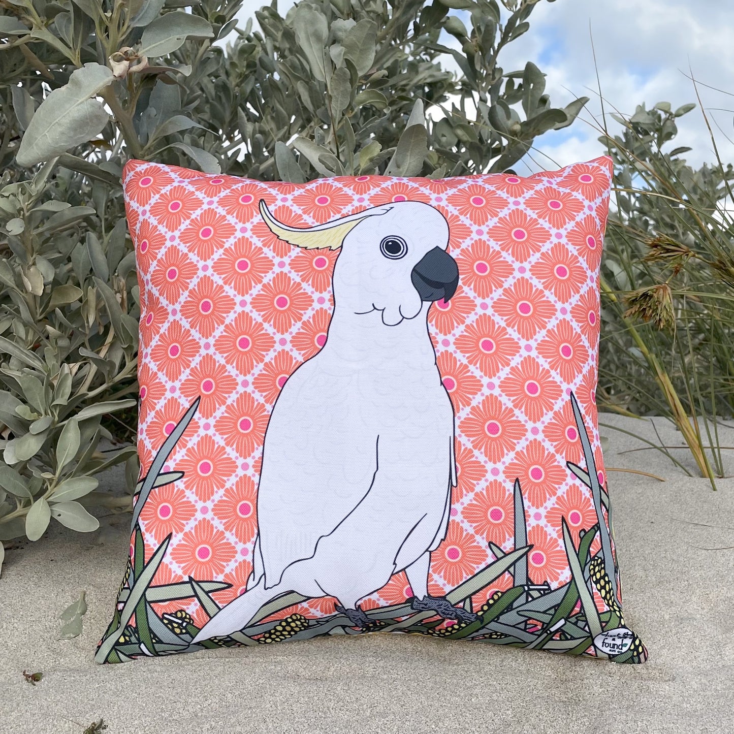 Decorative pillow with a white cockatoo design on a pink floral pattern LOST AND FOUND ART CO Cockatoo 40cm Cushion. 