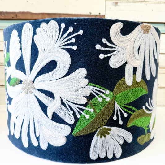 Embroidered white floral design on a navy blue velvet  lamp shade