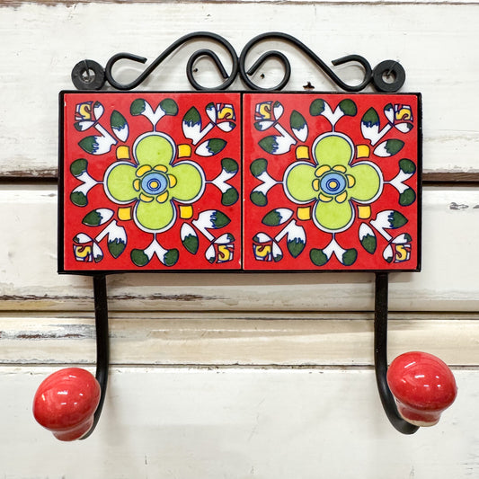 Decorative TILE wall hook with floral design on a red background