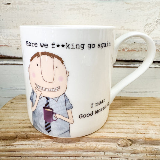 Mug with cartoon character and humorous text on a wooden surface