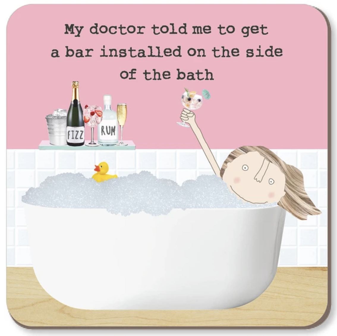 A square bath mat with rounded corners featuring a cartoon illustration of a woman in a bubble bath, a yellow rubber duck, a champagne bottle, and a pink background with the text, 'My doctor told me to get a bar installed on the side of the bath'.
Rosie Made a Thing |Coaster - Bath Bar