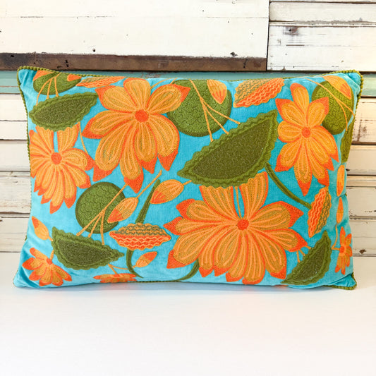 Floral pillow with orange flowers and green leaves on a blue background Ruby Star | Sunflower Cushion