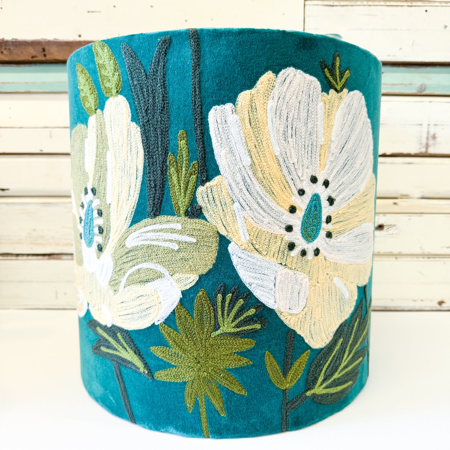 Decorative cylindrical pillow with floral embroidery 