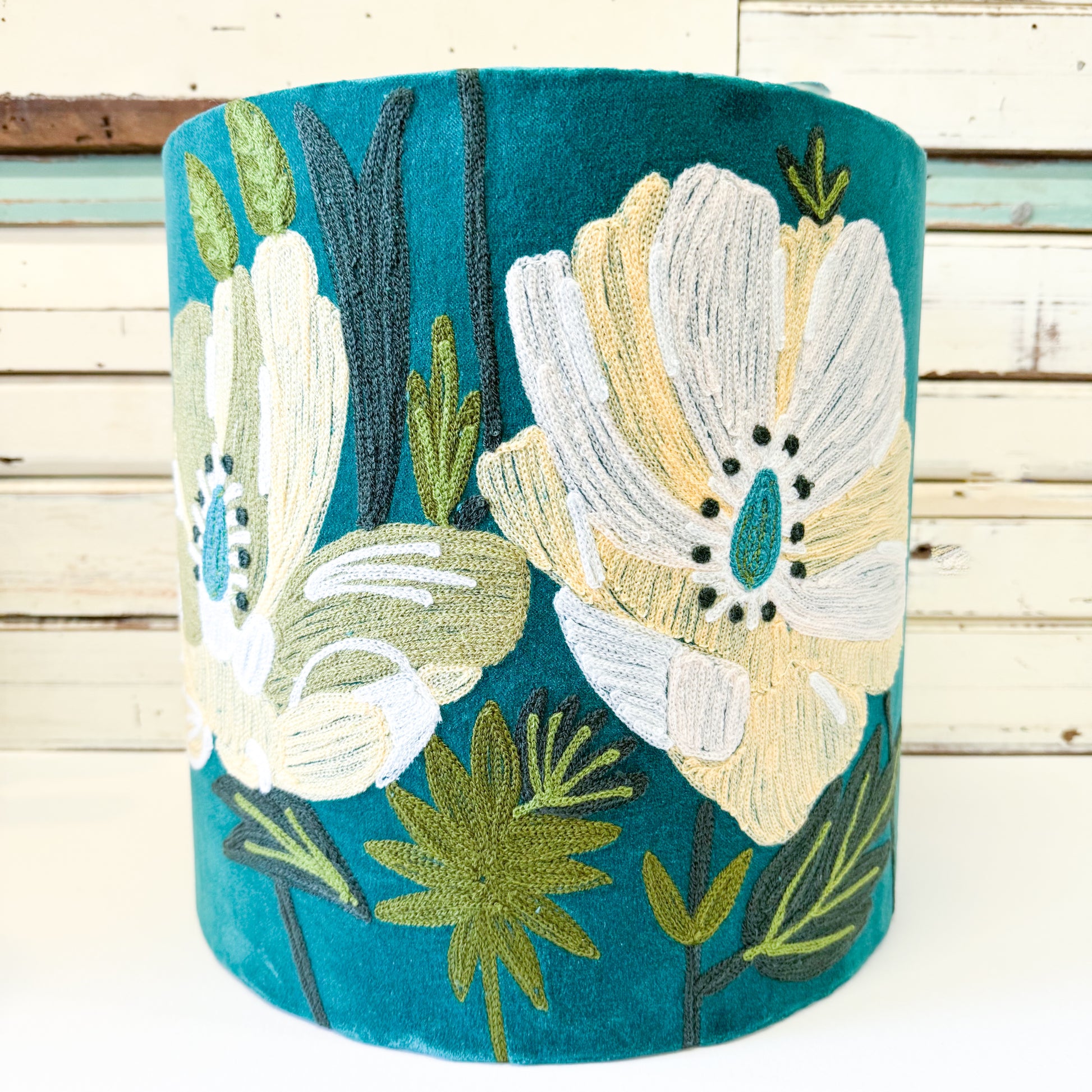 Decorative cylindrical pillow with floral embroidery 