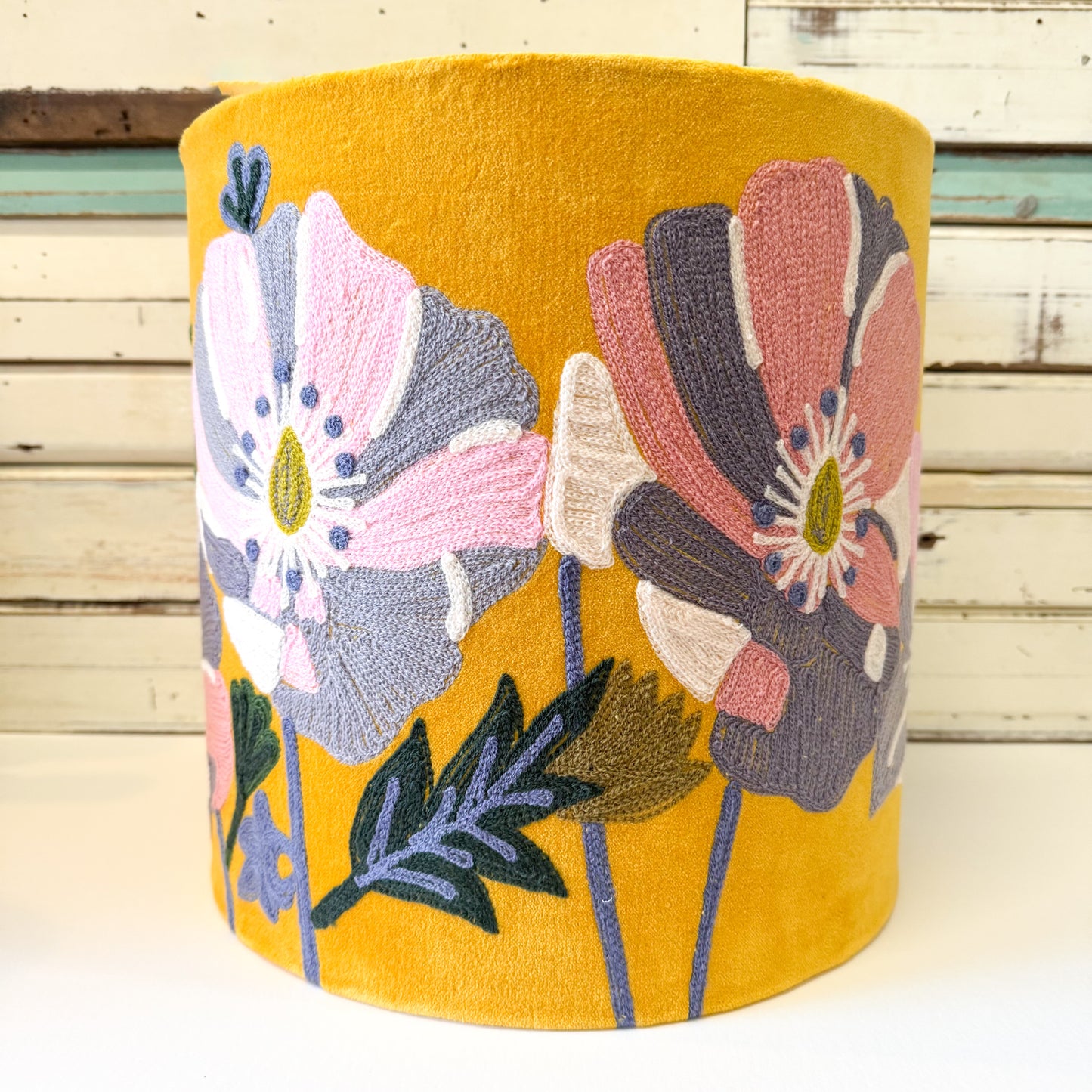 Yellow cylindrical lamp shade with floral embroidery on velvet