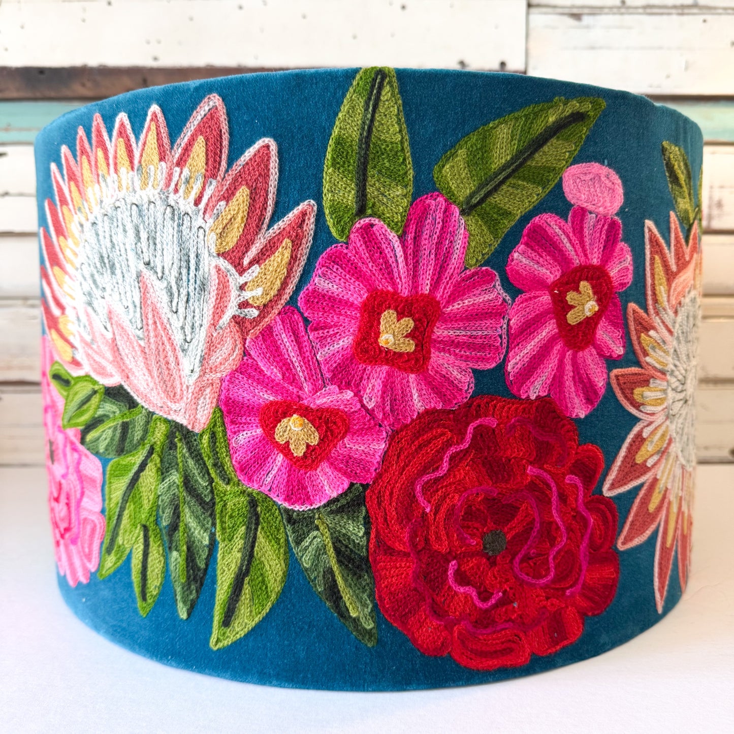 Ruby Star | Tropical Garden Teal Shade Embroidered floral design on a blue fabric background