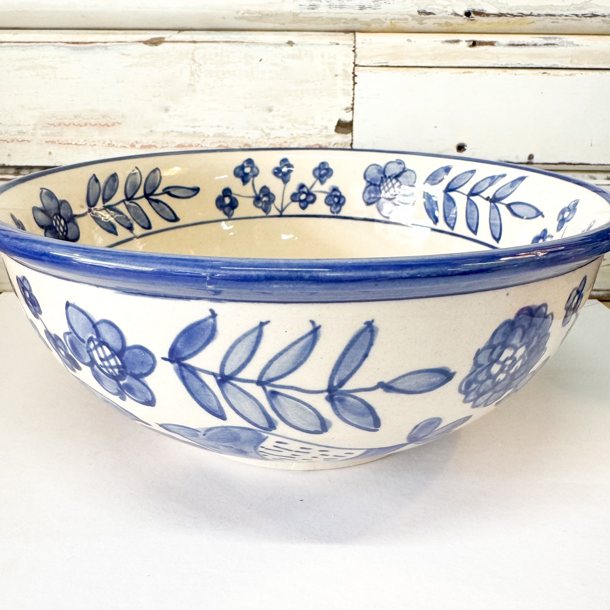 Status Collections - Blue Bird Salad Bowl. Ceramic bowl with blue floral patterns on a white background