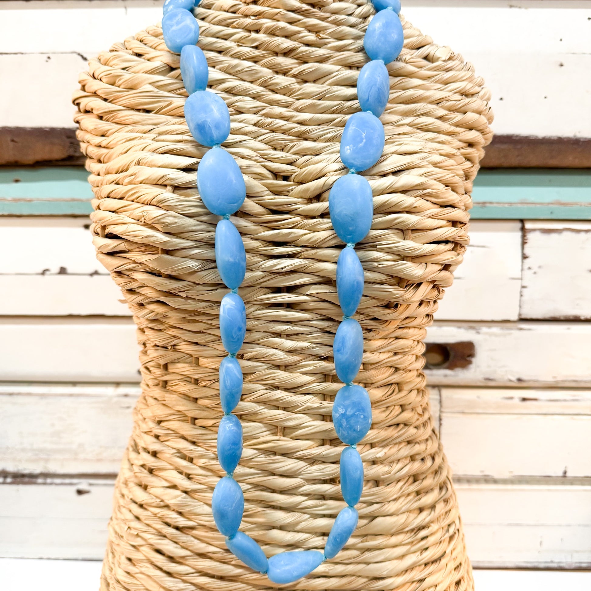 The_Brightside_Store_Pebble_Necklace_-_Light_Berry_Blue - string of oval resin beads in LIGHT BLUE tones 