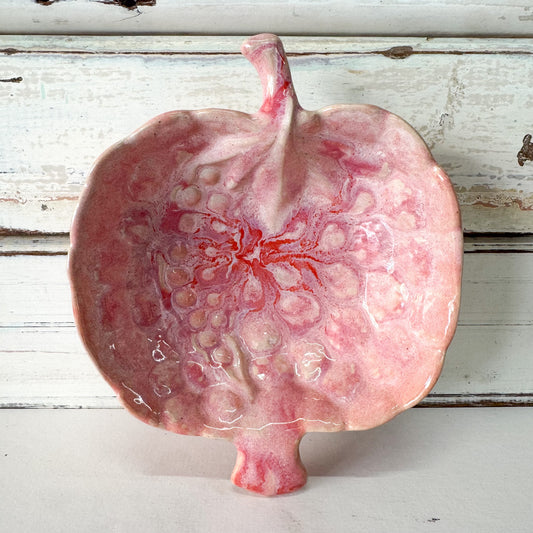Pink bowl with reactive glaze in the shape of a pomegranate