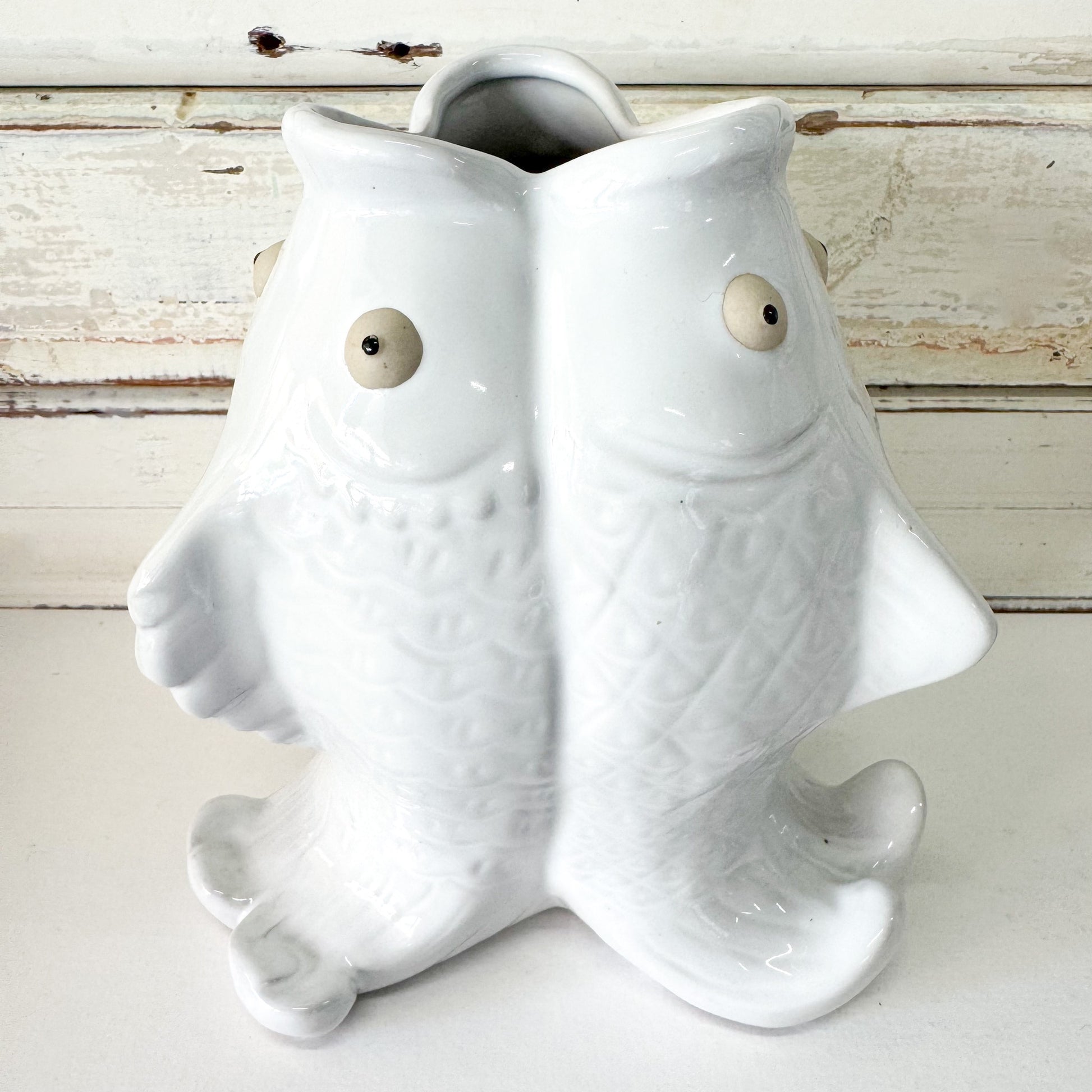 White ceramic fish-shaped vase on a wooden surface - The Brightside Store | Trio Fish Vase