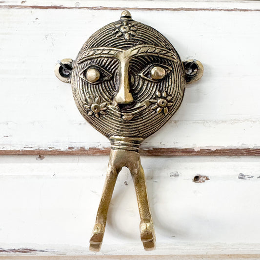 Decorative brass wall hook with face design 