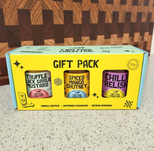 Gift pack with three canisters labeled 'Truffle Black Garlic Mustard', 'Spiced Mango Chutney', and 'Chilli Relish' 
Two Fool Collective - Two Fool Gift Pack