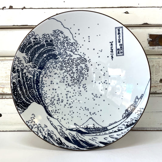 A large ceramic bowl with a white background featuring a blue and black wave pattern, inspired by Katsushika Hokusai's Great Wave painting. Concept Japan - Hokusai Fuji Large Bowl