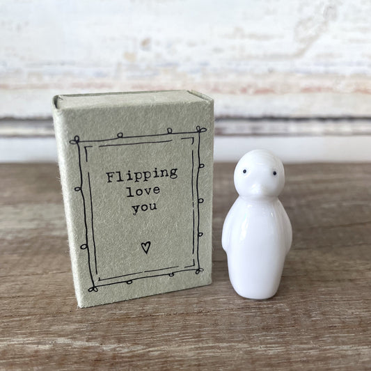 Heaven in Earth - Matchbox Penguin. A gloss glazed porcelain matchbox with a penguin design and the phrase 'Flipping love you' on the inside lid, placed next to its cardboard packaging.