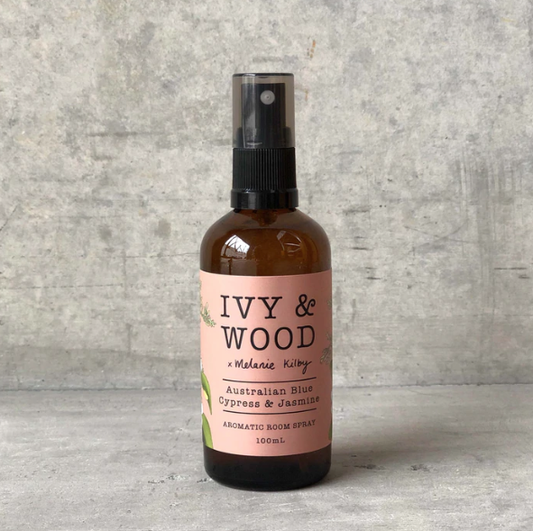 A bottle of Ivy & Wood room spray with Blue Cypress & Jasmine label, 